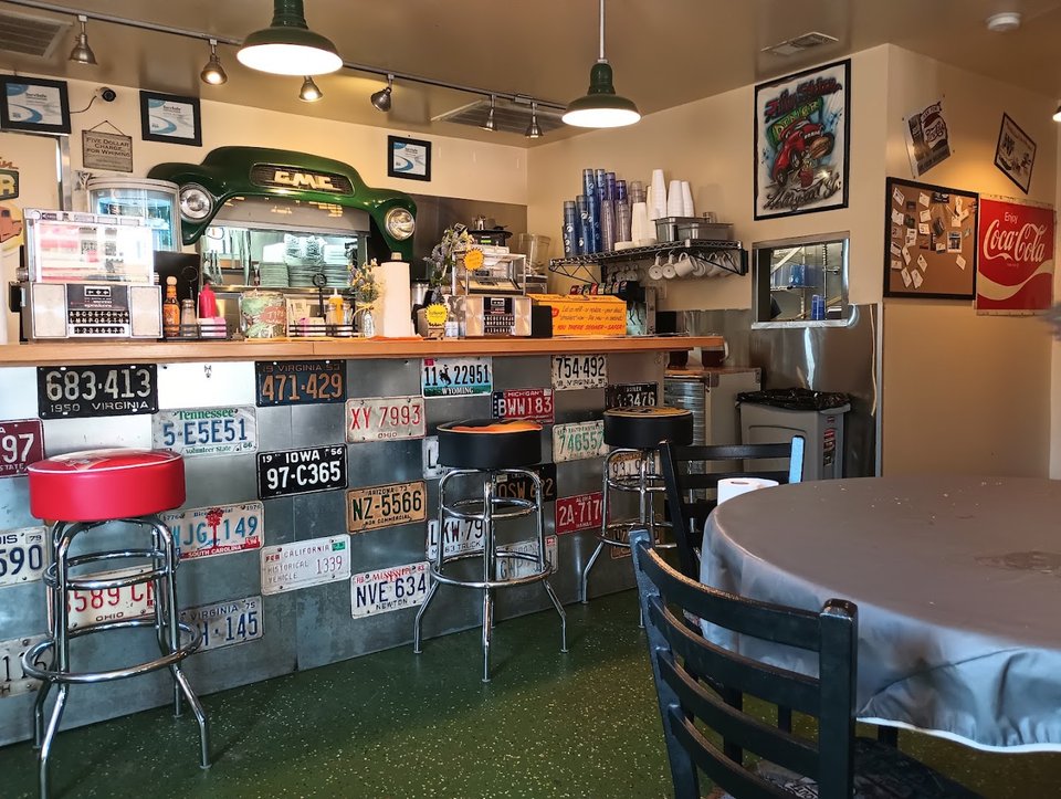 Classic diner tables with coffee cups and lunch plates.